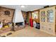 Vintage sunroom showcasing a brick fireplace, an adjacent kitchen view, and a decorative display cabinet at 1988 58Th N St, St Petersburg, FL 33710