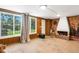 Retro sunroom featuring large windows, a decorative brick fireplace, and an outdoor grill view at 1988 58Th N St, St Petersburg, FL 33710
