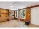 Sunroom with wood paneling, dual windows, outdoor view, and practical door for backyard access at 1988 58Th N St, St Petersburg, FL 33710