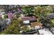 This aerial view shows a cozy home with a fenced yard and a detached garage and storage shed at 202 New Hope Rd, Brandon, FL 33510