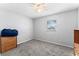 Cozy bedroom featuring plush gray carpeting, ceiling fan, and bright natural light at 202 New Hope Rd, Brandon, FL 33510