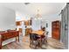 Inviting dining area with wooden table and chairs, chandelier, and a view into the kitchen at 202 New Hope Rd, Brandon, FL 33510