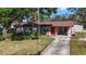 Charming single-story home boasts a well-manicured front yard and a welcoming red front door at 202 New Hope Rd, Brandon, FL 33510