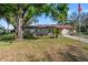 Attractive single-level home with a well-maintained front yard and mature shade trees at 202 New Hope Rd, Brandon, FL 33510