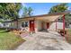 Lovely home with a convenient carport, brick-lined garden, and a bright red front door at 202 New Hope Rd, Brandon, FL 33510
