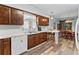 Kitchen area with wood cabinets, breakfast bar, and stainless-steel dishwasher at 202 New Hope Rd, Brandon, FL 33510
