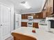 Kitchen featuring wooden cabinets, white countertops, and stainless-steel appliances at 202 New Hope Rd, Brandon, FL 33510