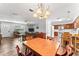 Open-concept living and dining area featuring hardwood floors and a chandelier at 202 New Hope Rd, Brandon, FL 33510