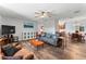 Open-concept living room features hardwood floors, ceiling fan, and plenty of natural light at 202 New Hope Rd, Brandon, FL 33510