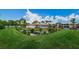Beautiful aerial view of pool and clubhouse surrounded by lush green landscape at 2571 Cyprus Dr # 1-105, Palm Harbor, FL 34684