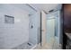 Modern bathroom features a stand-up shower with sleek marble tiling and mosaic tile accents at 2571 Cyprus Dr # 1-105, Palm Harbor, FL 34684