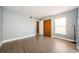Neutral bedroom with laminate floors, closet, and window at 2571 Cyprus Dr # 1-105, Palm Harbor, FL 34684