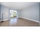 Well-lit bedroom with wood-style flooring and a large sliding glass door leading to the outside at 2571 Cyprus Dr # 1-105, Palm Harbor, FL 34684