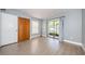 Cozy bedroom with wood floors, sliding glass door, and spacious closet at 2571 Cyprus Dr # 1-105, Palm Harbor, FL 34684