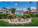 An inviting 'Lake Tarpon Villas' community sign is surrounded by well-manicured landscaping at 2571 Cyprus Dr # 1-105, Palm Harbor, FL 34684