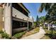 Low angle view of the condo showcasing the building's architecture and landscaping at 2571 Cyprus Dr # 1-105, Palm Harbor, FL 34684
