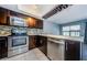 Stylish kitchen with stainless steel appliances, dark wood cabinets, and mosaic tile backsplash at 2571 Cyprus Dr # 1-105, Palm Harbor, FL 34684
