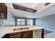 Bright kitchen island with a double sink, new dishwasher, and modern lighting fixture at 2571 Cyprus Dr # 1-105, Palm Harbor, FL 34684