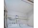 Functional laundry room with side by side washer and dryer, and metal storage shelves at 2571 Cyprus Dr # 1-105, Palm Harbor, FL 34684