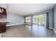 Open-concept living room with wood floors and large windows with curtains at 2571 Cyprus Dr # 1-105, Palm Harbor, FL 34684