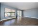 Spacious living room featuring wood floors, large windows, and neutral paint at 2571 Cyprus Dr # 1-105, Palm Harbor, FL 34684