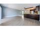 Bright open-concept living area with wood floors and modern kitchen at 2571 Cyprus Dr # 1-105, Palm Harbor, FL 34684