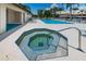 Relaxing community pool area offers a hot tub, lounge chairs, and inviting views at 2571 Cyprus Dr # 1-105, Palm Harbor, FL 34684