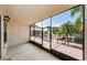 Spacious enclosed porch with screen and large windows overlooking deck, pool, and landscaping at 2571 Cyprus Dr # 1-105, Palm Harbor, FL 34684
