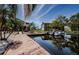 Scenic waterfront view with boats docked along the canal, enhanced by surrounding greenery at 2571 Cyprus Dr # 1-105, Palm Harbor, FL 34684