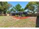 Landscaped backyard with a screened pool and privacy fence at 2715 Willow Oaks Dr, Valrico, FL 33594