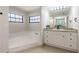 A bathroom with a soaking tub and vanity at 2715 Willow Oaks Dr, Valrico, FL 33594