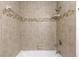 Neutral bathroom features a bathtub shower combination and neutral tile at 2715 Willow Oaks Dr, Valrico, FL 33594