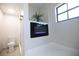 Bathroom featuring a built-in fireplace, a potted plant, a window, and a toilet at 2715 Willow Oaks Dr, Valrico, FL 33594