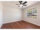 Bright bedroom features hardwood floors, a ceiling fan, and a window offering natural light at 2715 Willow Oaks Dr, Valrico, FL 33594