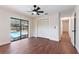 Bedroom with wood floors, ceiling fan, closet, and sliding glass door to a pool at 2715 Willow Oaks Dr, Valrico, FL 33594