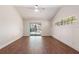 Bedroom features wood floors, vaulted ceiling, and sliding doors to the pool area at 2715 Willow Oaks Dr, Valrico, FL 33594