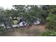 Charming home with lush landscaping, mature trees, and a freshly painted white exterior at 2715 Willow Oaks Dr, Valrico, FL 33594