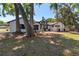 Charming brick home featuring a manicured lawn, trees, and a large double door entry at 2715 Willow Oaks Dr, Valrico, FL 33594