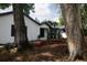 Beautifully landscaped front yard with mature trees framing a charming white-brick home at 2715 Willow Oaks Dr, Valrico, FL 33594