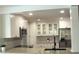 Modern kitchen featuring stainless steel appliances and white cabinets with granite countertops at 2715 Willow Oaks Dr, Valrico, FL 33594