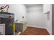 Laundry room featuring water heater, utility sink, and storage shelf at 2715 Willow Oaks Dr, Valrico, FL 33594