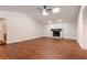 Spacious living room featuring wood floors, a brick fireplace, vaulted ceilings, and natural light from the skylights at 2715 Willow Oaks Dr, Valrico, FL 33594
