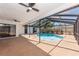 Sparkling pool within a screened enclosure with ceiling fans and patio at 2715 Willow Oaks Dr, Valrico, FL 33594