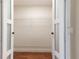 Walk-in closet featuring hardwood floors, wire shelving and double doors at 2715 Willow Oaks Dr, Valrico, FL 33594