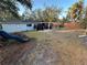 Expansive backyard featuring covered patio area and mature trees at 287 Belleair Ne Dr, St Petersburg, FL 33704