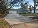 Charming single-story home with an attached garage and a well-manicured front yard at 287 Belleair Ne Dr, St Petersburg, FL 33704