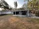 View of the patio area with furniture and ceiling fans, perfect for outdoor entertaining and relaxation at 287 Belleair Ne Dr, St Petersburg, FL 33704
