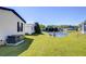 Lush backyard with green lawn and a view of the pond for relaxation at 3051 Shady Creek Dr, Wesley Chapel, FL 33543