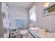 Bathroom featuring a blue vanity, toilet, and shower with a decorative shower curtain at 3051 Shady Creek Dr, Wesley Chapel, FL 33543