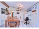 Bright dining area showcasing a wooden table set complemented by stylish decor and ample natural light at 3051 Shady Creek Dr, Wesley Chapel, FL 33543